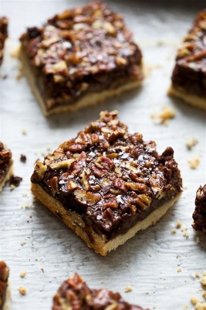 Chocolate pecan pie bars topped with flaky sea salt.