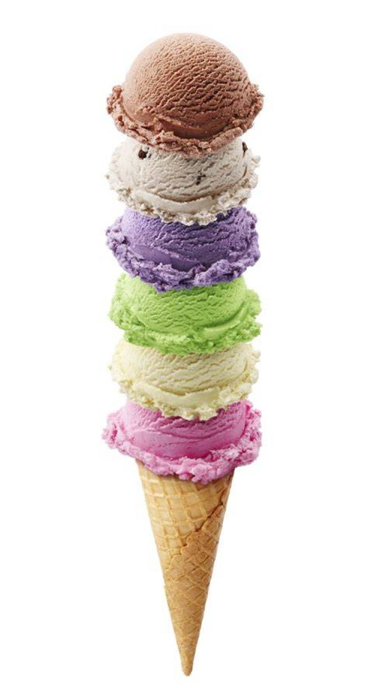 Stack of three ice cream sandwiches on a grey table.